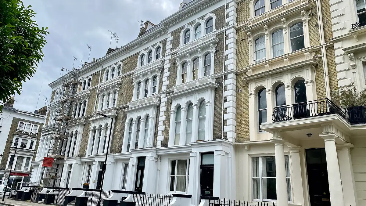 A white stucco Victorian terrace with columned porches on Leinster Square, Bayswater