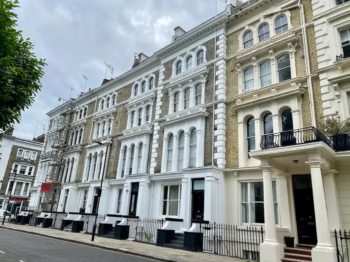 A white stucco Victorian terrace with columned porches on Leinster Square, Bayswater