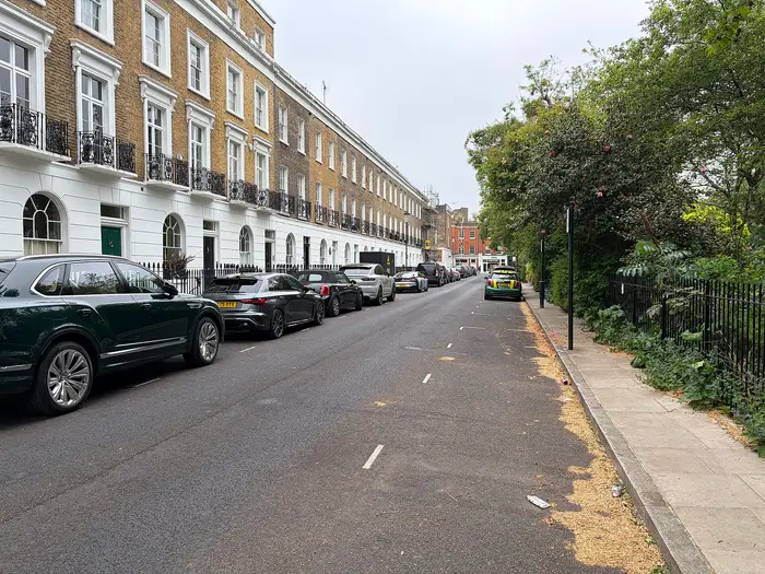 A stucco and brick terrace with iron balconies on Paultons Square, Chelsea