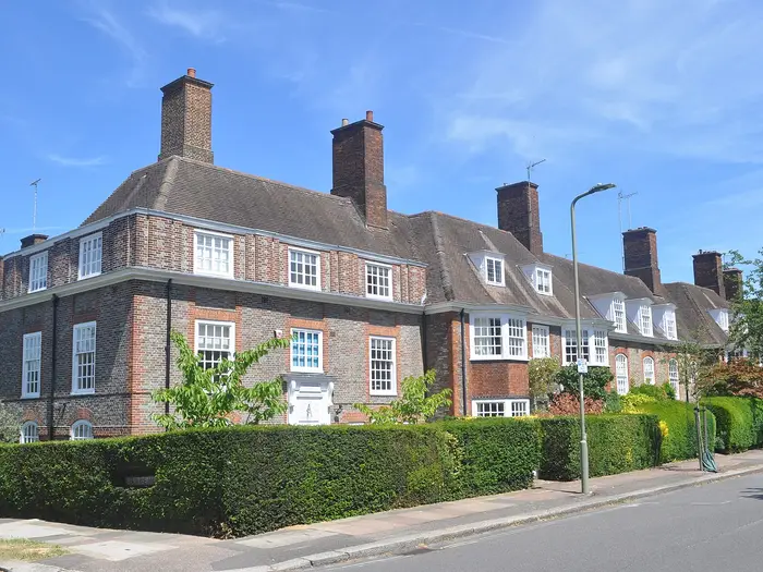 Arts and Crafts brick houses with tall chimneys on North Square, Hampstead Garden Suburb