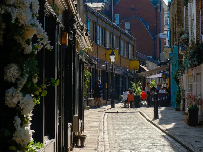 A cobbled lane lined with shops in Hampstead village