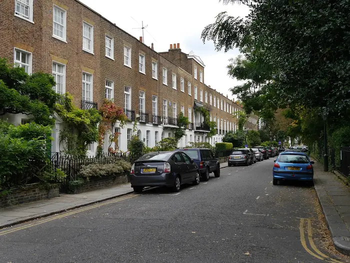 A Regency brick terrace with stucco ground floors and wisteria on Edwardes Square, Kensington