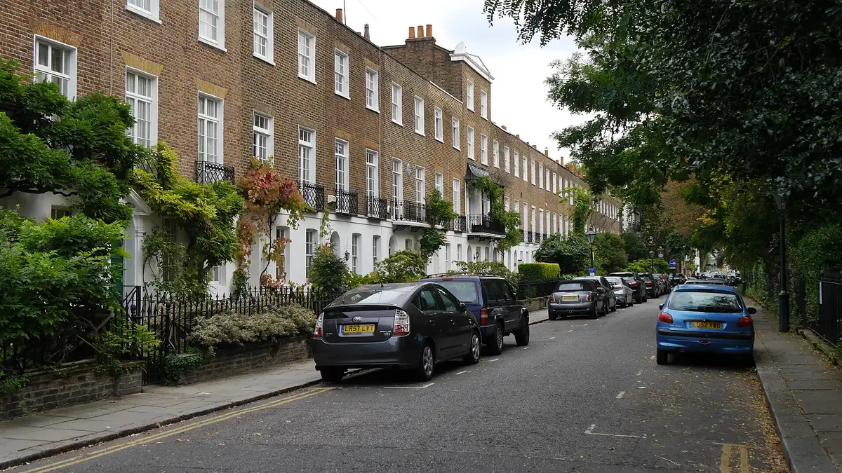 A Regency brick terrace with stucco ground floors and wisteria on Edwardes Square, Kensington