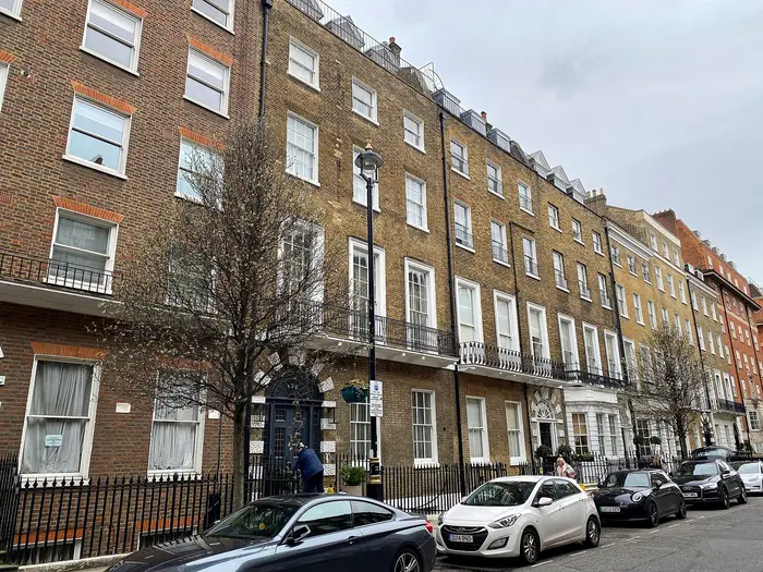 A Georgian brick terrace with iron balconies on Harley Street, Marylebone