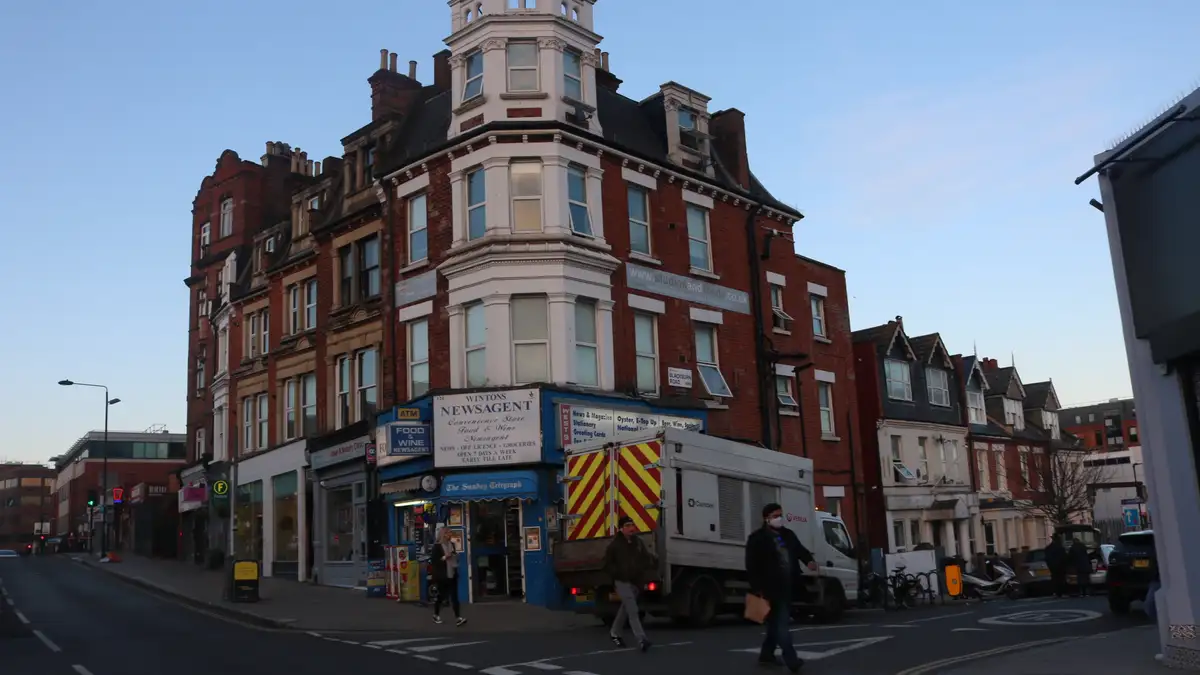 A red-brick block with shops below on West End Lane, West Hampstead