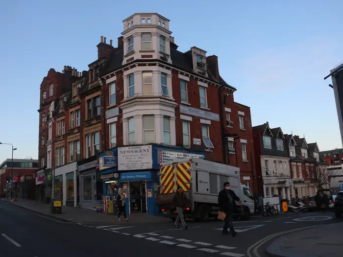 A red-brick block with shops below on West End Lane, West Hampstead